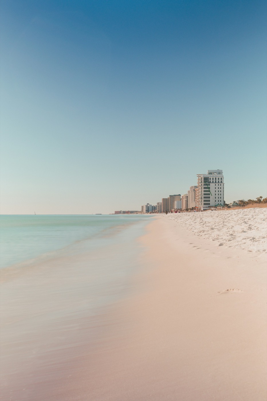 White sand shoreline in Destin with condos in the distance